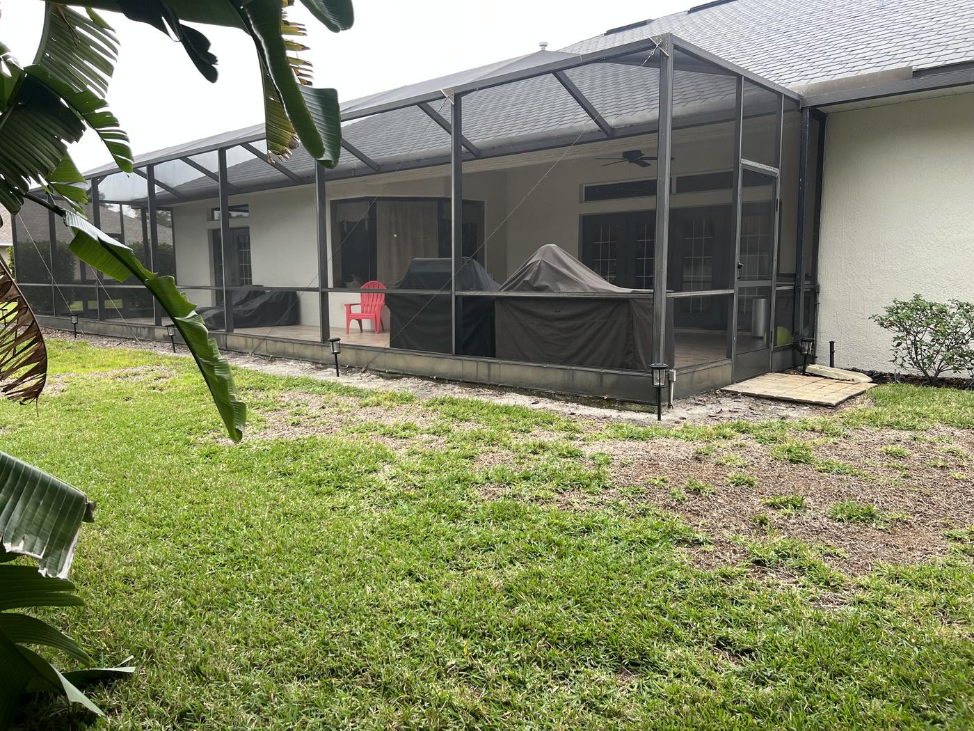 Winter Haven pool and outdoor kitchen: Backyard and screened patio, before